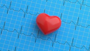 Heart stress ball on top of heart rhythm patterns