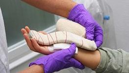 Doctor applying bandage after a carpal tunnel release surgery
